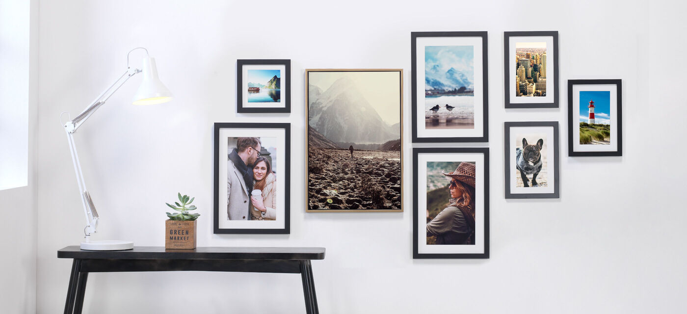 Gallery wall of personalised framed wall art from family photos to travel photos.